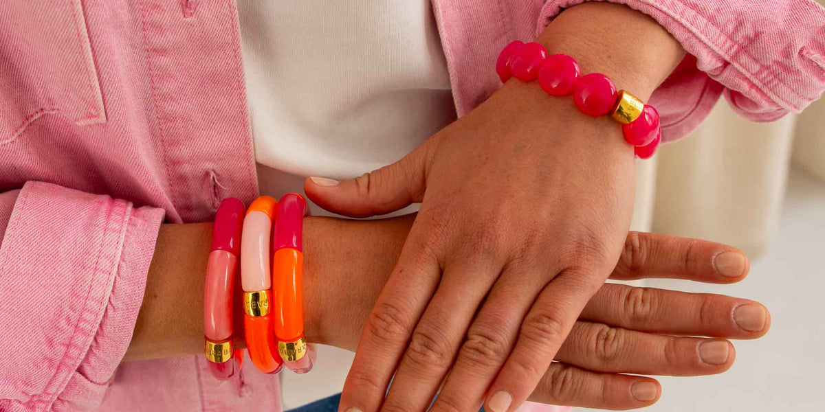 Bracelets colorés femme Pipoca et Bombom rose et orange portés au poignet