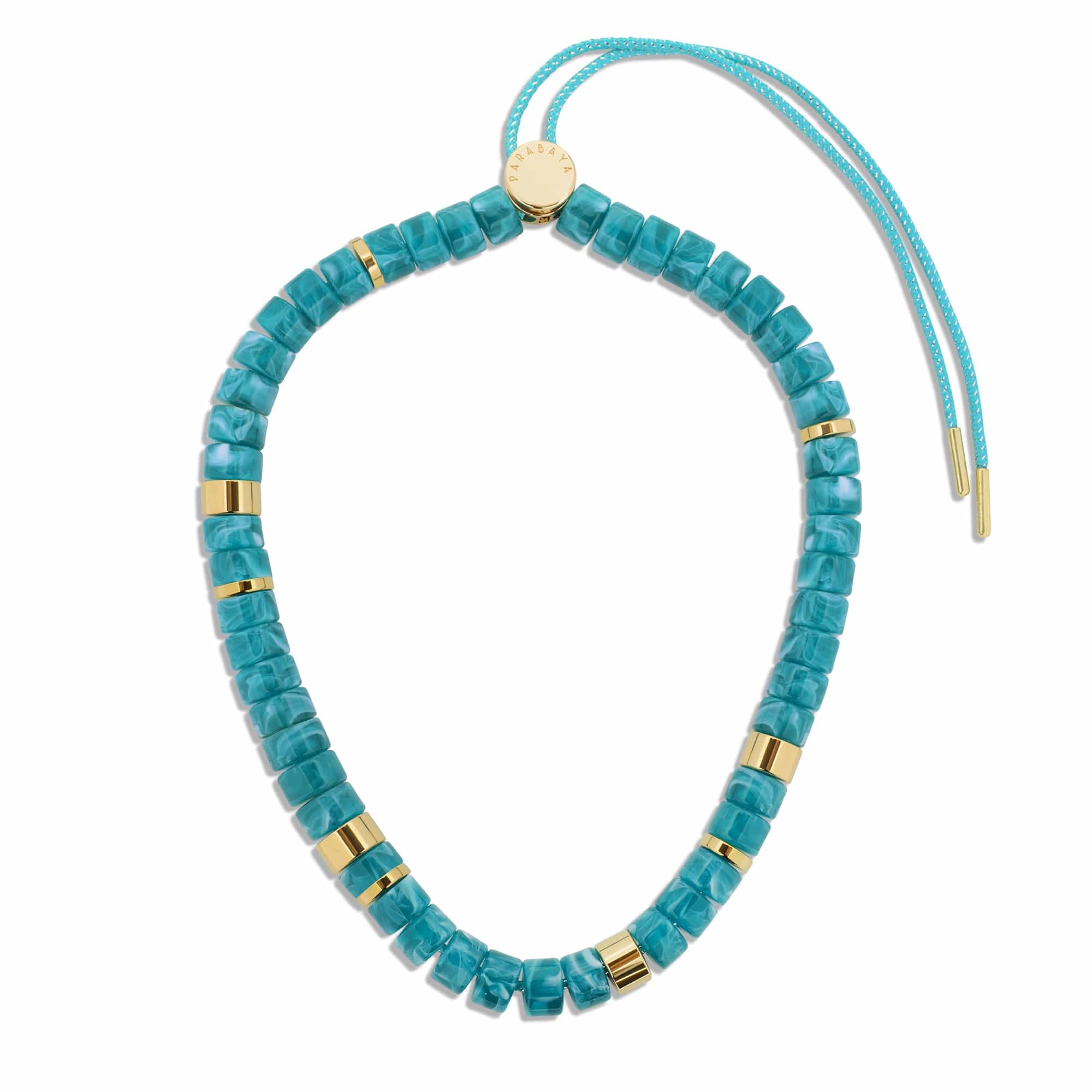 Description Le collier Praia Turquesa se distingue par ses perles bleu turquoise marbré, associées à des touches d’acier doré disposées de manière asymétrique. Une combinaison lumineuse et estivale qui évoque les eaux cristallines. Monté sur un cordon délicatement rehaussé d’un fil lurex, il capte la lumière et apporte une touche éclatante à la silhouette. Sa longueur réglable permet de le porter de différentes façons, plus court ou plus long selon l’envie. Le fermoir est délicatement gravé du logo Parabaya